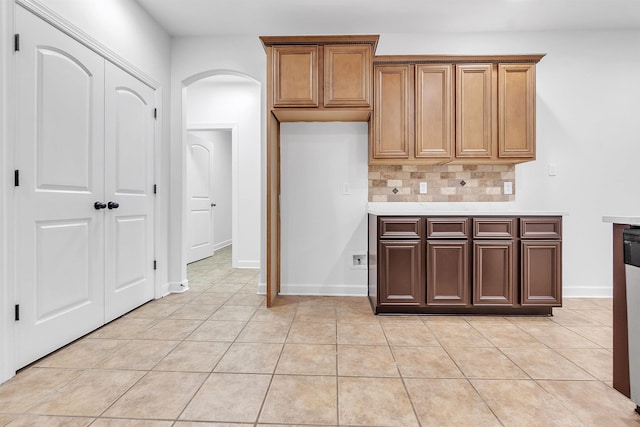 1235 Gimel Ln, Cordova, TN 38016 - kitchen with arched walkways, tasteful backsplash, light tile patterned floors, light countertops, and baseboards