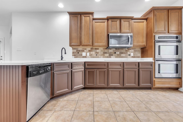 1235 Gimel Ln, Cordova, TN 38016 - kitchen featuring stainless steel appliances, recessed lighting, light countertops, a sink, and tasteful backsplash