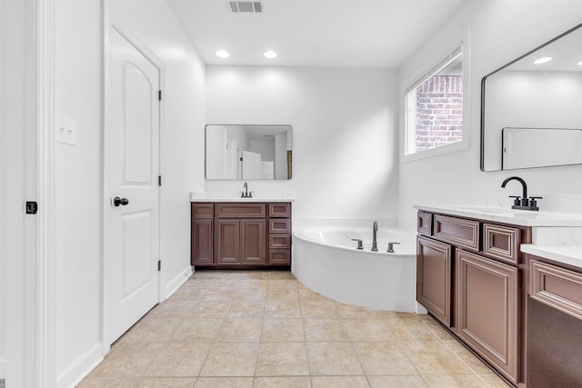 1235 Gimel Ln, Cordova, TN 38016 - full bath with a garden tub, two vanities, and recessed lighting