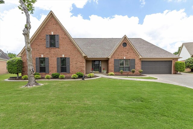 3187 Valley Lake Dr, Bartlett, TN 38135 - view of front of house featuring brick siding, an attached garage, driveway, roof with shingles, and a front yard