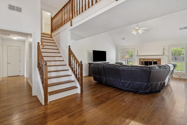 3187 Valley Lake Dr, Bartlett, TN 38135 - living area featuring ceiling fan, wood finished floors, high vaulted ceiling, stairs, and baseboards