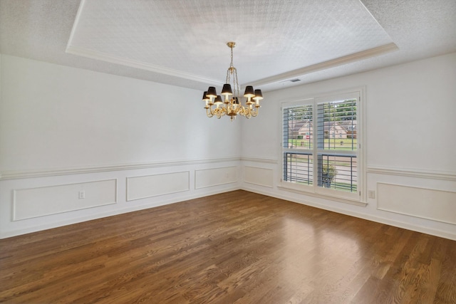 3187 Valley Lake Dr, Bartlett, TN 38135 - spare room featuring a raised ceiling, a chandelier, dark wood finished floors, wainscoting, and a textured ceiling