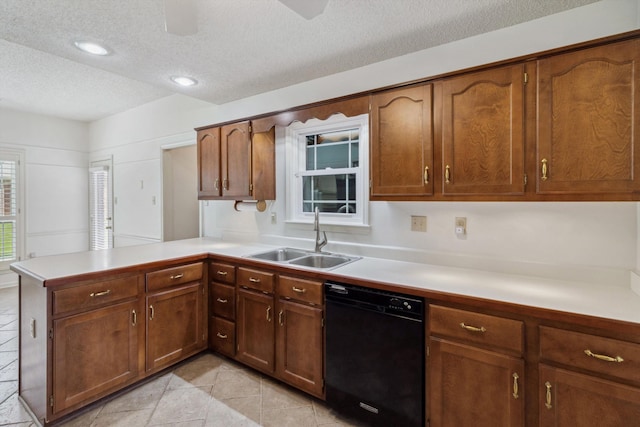 3187 Valley Lake Dr, Bartlett, TN 38135 - kitchen with black dishwasher, a sink, a textured ceiling, a peninsula, and light countertops