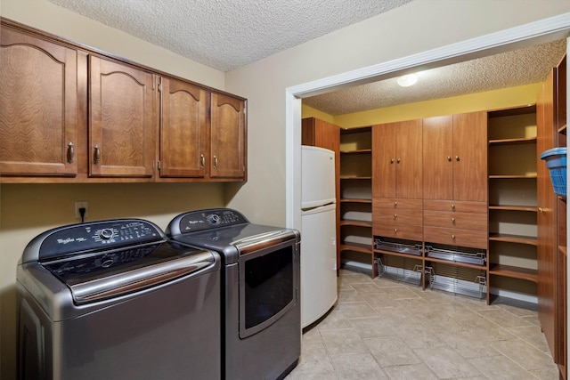 3187 Valley Lake Dr, Bartlett, TN 38135 - washroom with cabinet space, a textured ceiling, and separate washer and dryer