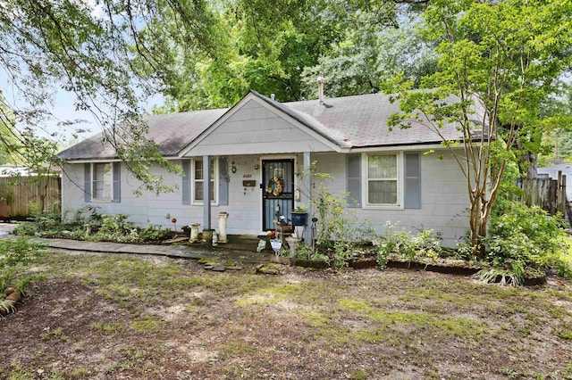 4381 Embassy Dr, Memphis, TN 38108 - ranch-style house with fence, a shingled roof, and a porch