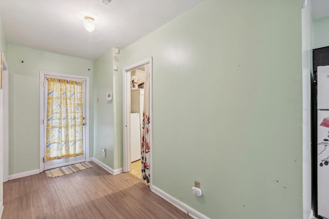 4381 Embassy Dr, Memphis, TN 38108 - spare room featuring wood finished floors, baseboards, and washer / dryer