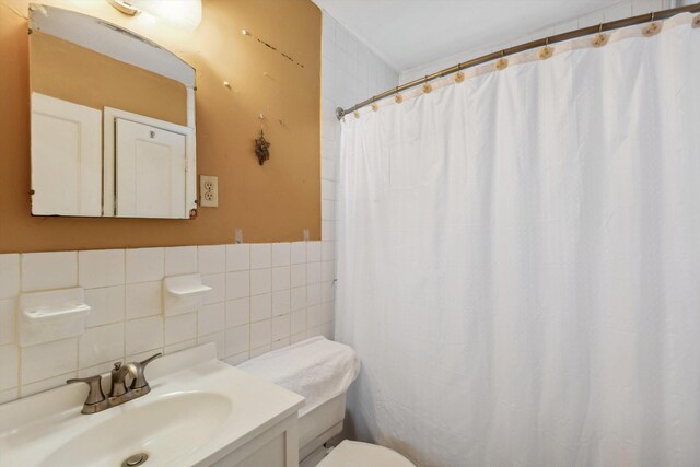 4381 Embassy Dr, Memphis, TN 38108 - bathroom with tile walls, toilet, tasteful backsplash, vanity, and curtained shower