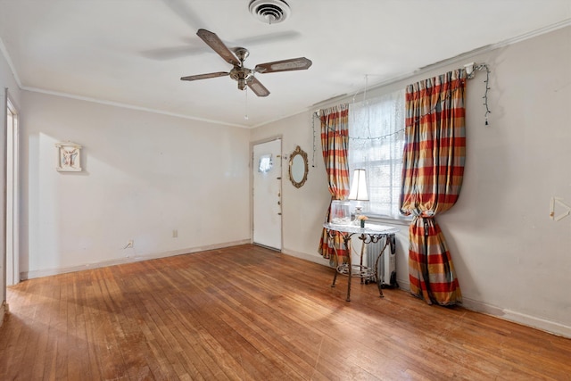 4381 Embassy Dr, Memphis, TN 38108 - entrance foyer featuring wood-type flooring, a ceiling fan, crown molding, healthy amount of natural light, and baseboards