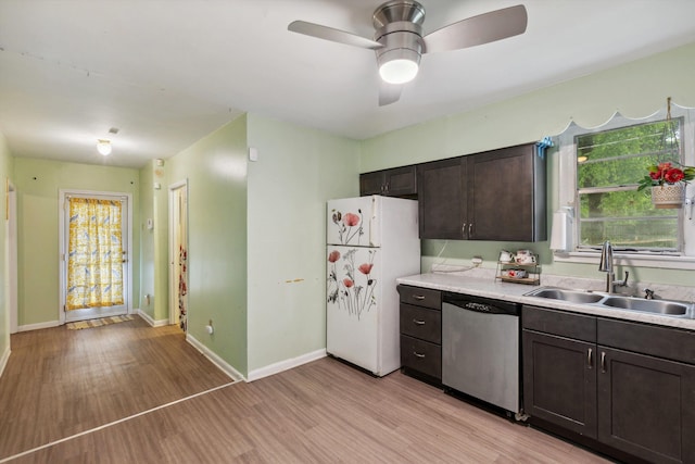 4381 Embassy Dr, Memphis, TN 38108 - kitchen with dishwasher, a sink, freestanding refrigerator, dark brown cabinets, and light wood-style flooring