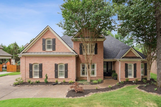 215 Ivy Grove Ln, Collierville, TN 38017 - view of front of property featuring brick siding, a front lawn, and roof with shingles