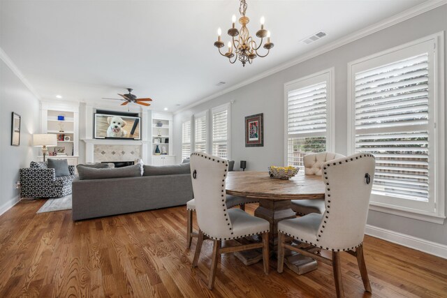 215 Ivy Grove Ln, Collierville, TN 38017 - dining room with ornamental molding, baseboards, wood finished floors, a chandelier, and a ceiling fan