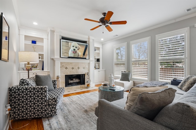 215 Ivy Grove Ln, Collierville, TN 38017 - living area with wood finished floors, ornamental molding, ceiling fan, a fireplace, and recessed lighting
