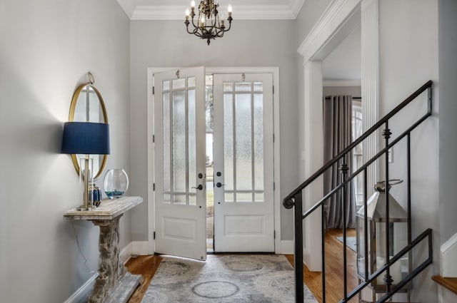 215 Ivy Grove Ln, Collierville, TN 38017 - entrance foyer featuring wood finished floors, stairway, a chandelier, ornamental molding, and baseboards