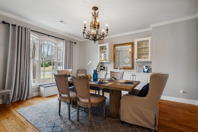 215 Ivy Grove Ln, Collierville, TN 38017 - dining room featuring a chandelier, wood finished floors, baseboards, and ornamental molding