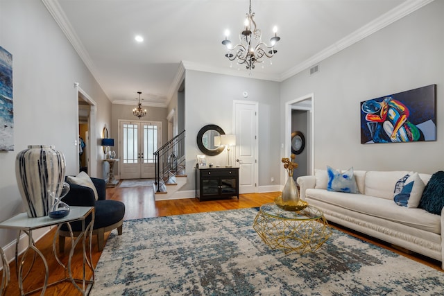 215 Ivy Grove Ln, Collierville, TN 38017 - living area with a chandelier, wood finished floors, stairway, baseboards, and crown molding