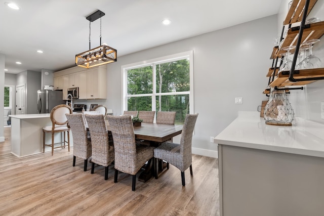 dining room featuring light wood-type flooring, recessed lighting, a chandelier, and baseboards