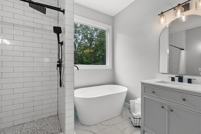 bathroom with tiled shower, marble finish floors, vanity, and a soaking tub