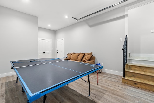 recreation room featuring wood finished floors, baseboards, recessed lighting, and attic access