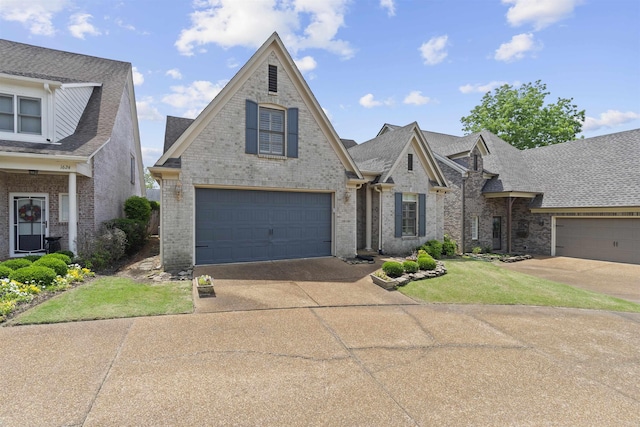 view of front of house with driveway, brick siding, and a shingled roof