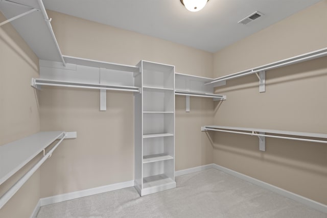 walk in closet with carpet