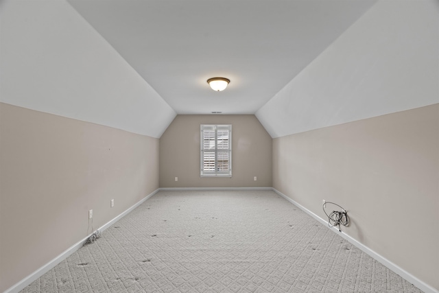 bonus room featuring lofted ceiling, baseboards, and carpet flooring