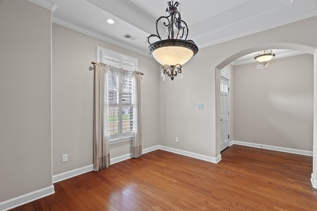 unfurnished room featuring arched walkways, ornamental molding, hardwood / wood-style floors, baseboards, and recessed lighting