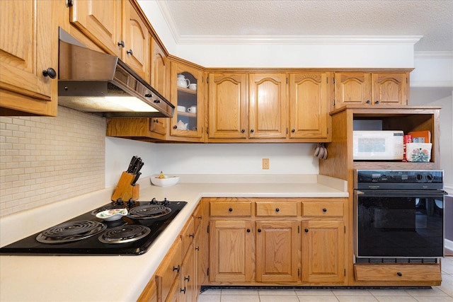 7733 Quick Fox Cv, Memphis, TN 38016 - kitchen featuring black appliances, under cabinet range hood, ornamental molding, light countertops, and backsplash