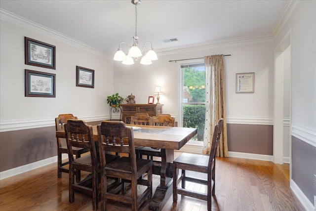 7733 Quick Fox Cv, Memphis, TN 38016 - dining room featuring a chandelier, wood finished floors, ornamental molding, and baseboards