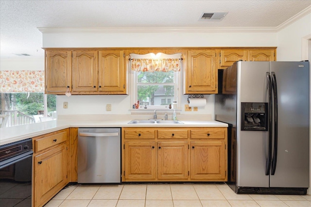 7733 Quick Fox Cv, Memphis, TN 38016 - kitchen with stainless steel appliances, a sink, light countertops, plenty of natural light, and ornamental molding