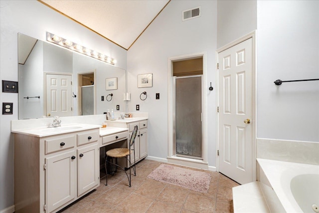 7733 Quick Fox Cv, Memphis, TN 38016 - bathroom with a shower stall, lofted ceiling, tile patterned floors, vanity, and a bath