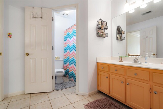 7733 Quick Fox Cv, Memphis, TN 38016 - bathroom with tile patterned floors, baseboards, vanity, toilet, and curtained shower