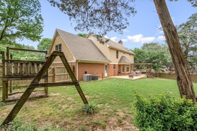 7733 Quick Fox Cv, Memphis, TN 38016 - rear view of property featuring brick siding, a patio area, central AC, and roof with shingles