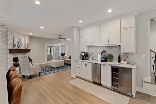 787 Pearson Oaks Dr, Collierville, TN 38017 - kitchen with beverage cooler, open floor plan, white cabinets, light countertops, and recessed lighting