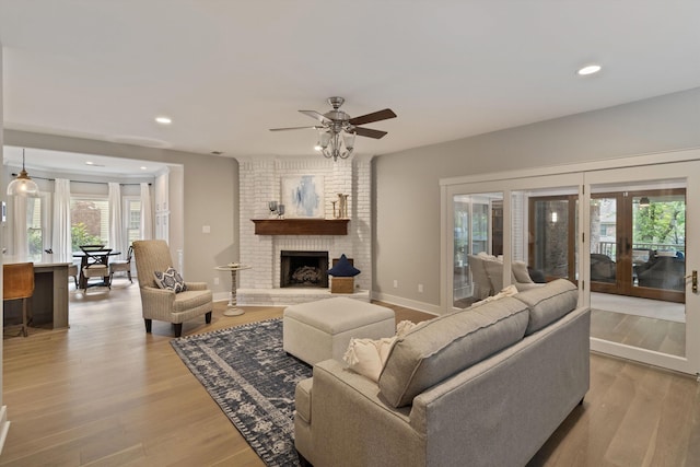 787 Pearson Oaks Dr, Collierville, TN 38017 - living area featuring plenty of natural light, light wood-style flooring, french doors, recessed lighting, and a brick fireplace