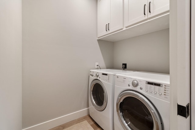 787 Pearson Oaks Dr, Collierville, TN 38017 - laundry area with cabinet space, washer and dryer, baseboards, and light wood-style flooring