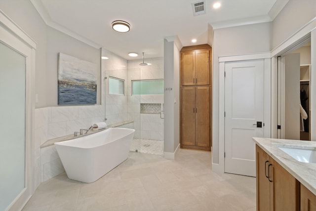 787 Pearson Oaks Dr, Collierville, TN 38017 - bathroom with a stall shower, a closet, ornamental molding, a soaking tub, and tile patterned flooring