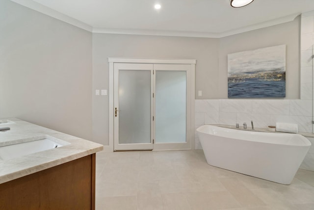 787 Pearson Oaks Dr, Collierville, TN 38017 - full bath featuring a soaking tub, tile patterned flooring, double vanity, ornamental molding, and tile walls