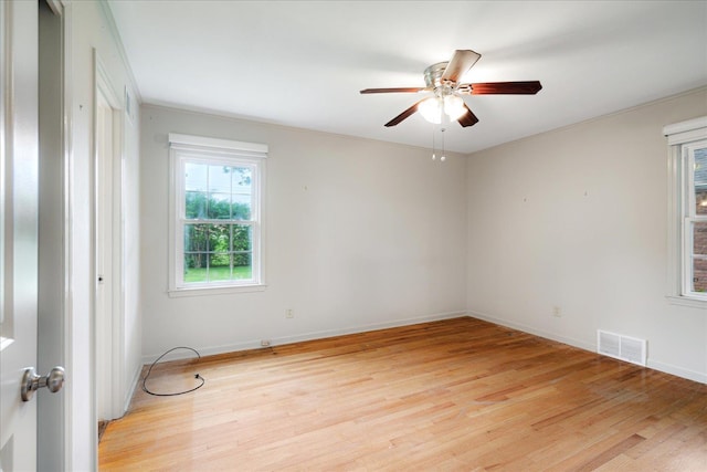 1079 Woodview Dr, Memphis, TN 38117 - unfurnished room featuring light wood-type flooring, a ceiling fan, and baseboards