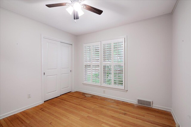 1079 Woodview Dr, Memphis, TN 38117 - unfurnished bedroom with light wood-type flooring, baseboards, crown molding, and a ceiling fan
