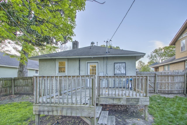 1975 Walker Ave, Memphis, TN 38104 - back of house with stucco siding, a fenced backyard, and a deck