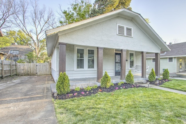 1975 Walker Ave, Memphis, TN 38104 - bungalow-style house featuring a porch and stucco siding
