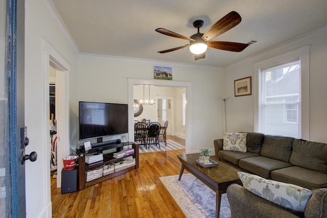 1975 Walker Ave, Memphis, TN 38104 - living room featuring a chandelier, crown molding, light wood-style flooring, and ceiling fan