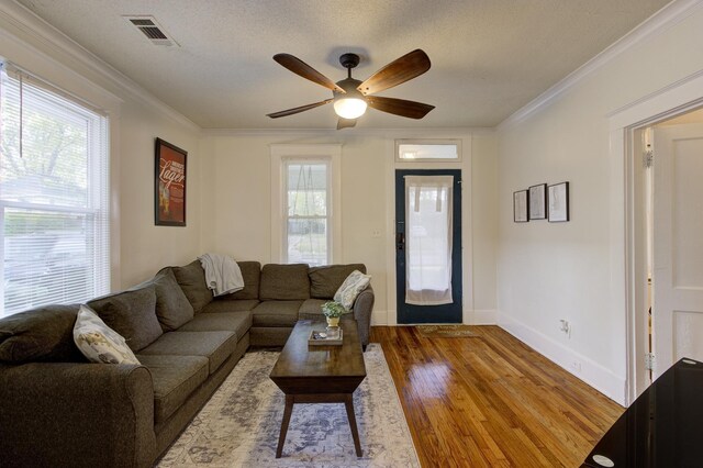 1975 Walker Ave, Memphis, TN 38104 - living area with a ceiling fan, wood finished floors, crown molding, baseboards, and a textured ceiling
