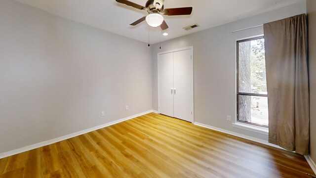 3983 Grahamdale Cir Unit 3983B, Memphis, TN 38122 - unfurnished bedroom with light wood-style flooring, baseboards, recessed lighting, a closet, and a ceiling fan