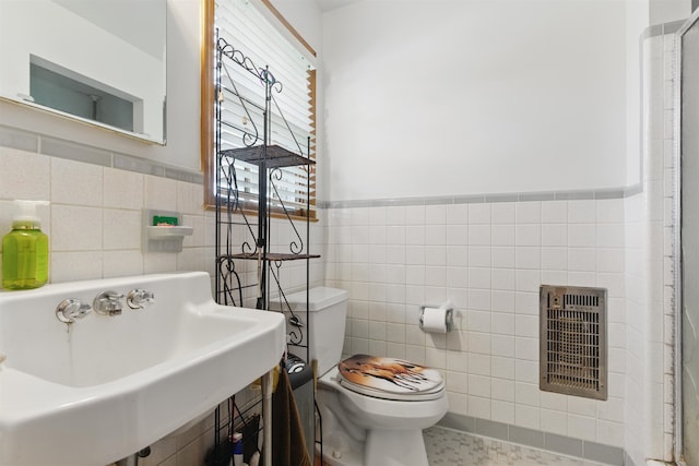 1980 Campbell Rd, Millington, TN 38053 - bathroom with tile walls, toilet, wainscoting, and a sink