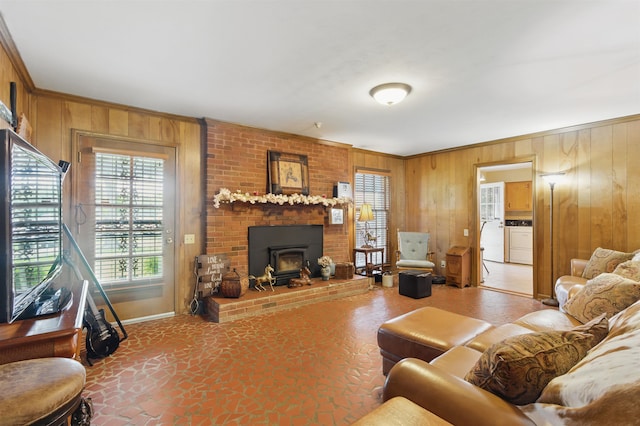 1980 Campbell Rd, Millington, TN 38053 - living area featuring independent washer and dryer, wood walls, crown molding, a wood stove, and baseboards