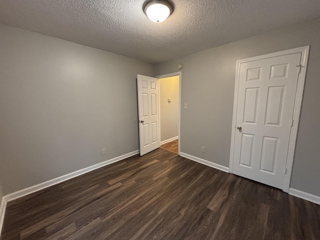 4334 Cleopatra Rd, Unicorp/Memphis, TN 38128 - unfurnished bedroom featuring dark wood-type flooring, a textured ceiling, and baseboards