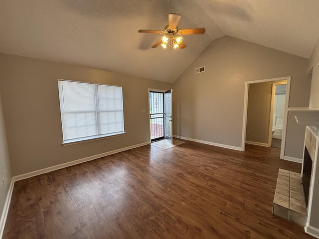 4334 Cleopatra Rd, Unicorp/Memphis, TN 38128 - unfurnished living room featuring ceiling fan, vaulted ceiling, dark wood-style floors, a brick fireplace, and baseboards