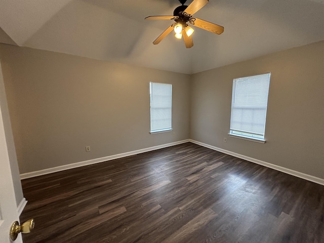 4334 Cleopatra Rd, Unicorp/Memphis, TN 38128 - empty room with healthy amount of natural light, vaulted ceiling, dark wood-style flooring, and baseboards