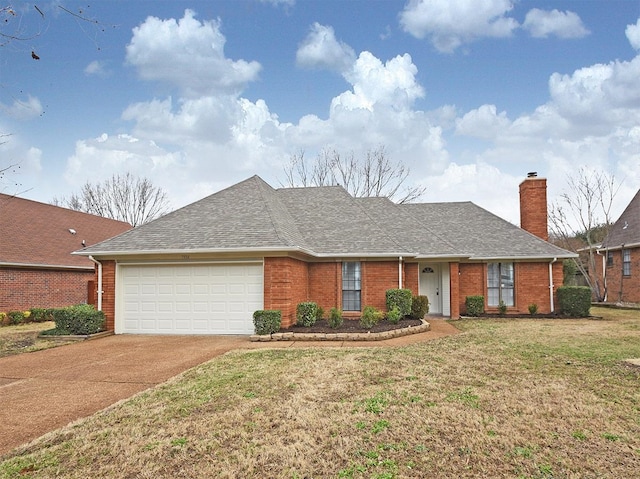 view of front facade with an attached garage, driveway, brick siding, and a chimney